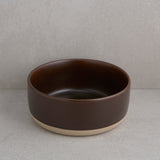 Brown ceramic bowl on a gray background