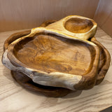 Wooden serving trays on a light wooden surface