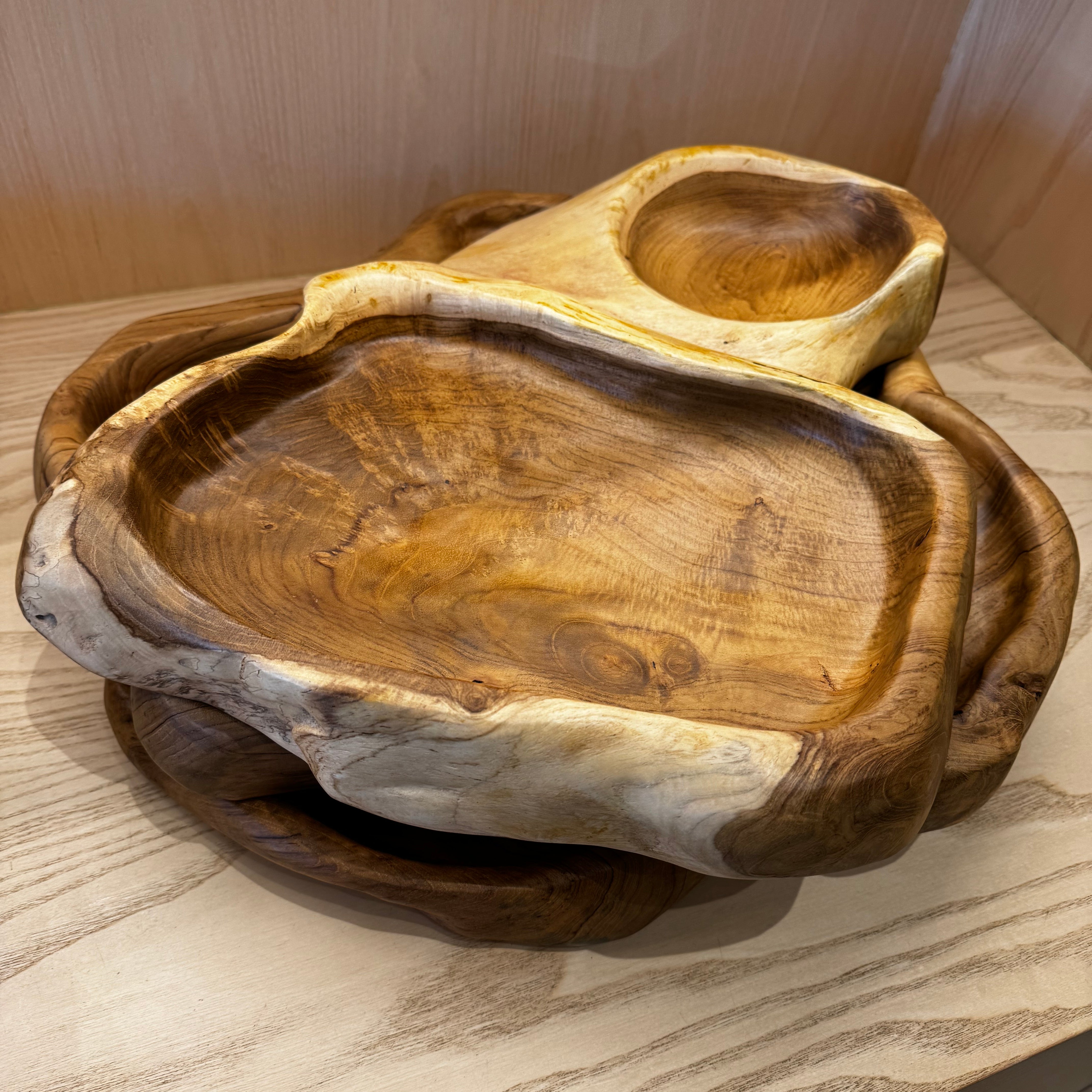 Wooden serving trays on a light wooden surface