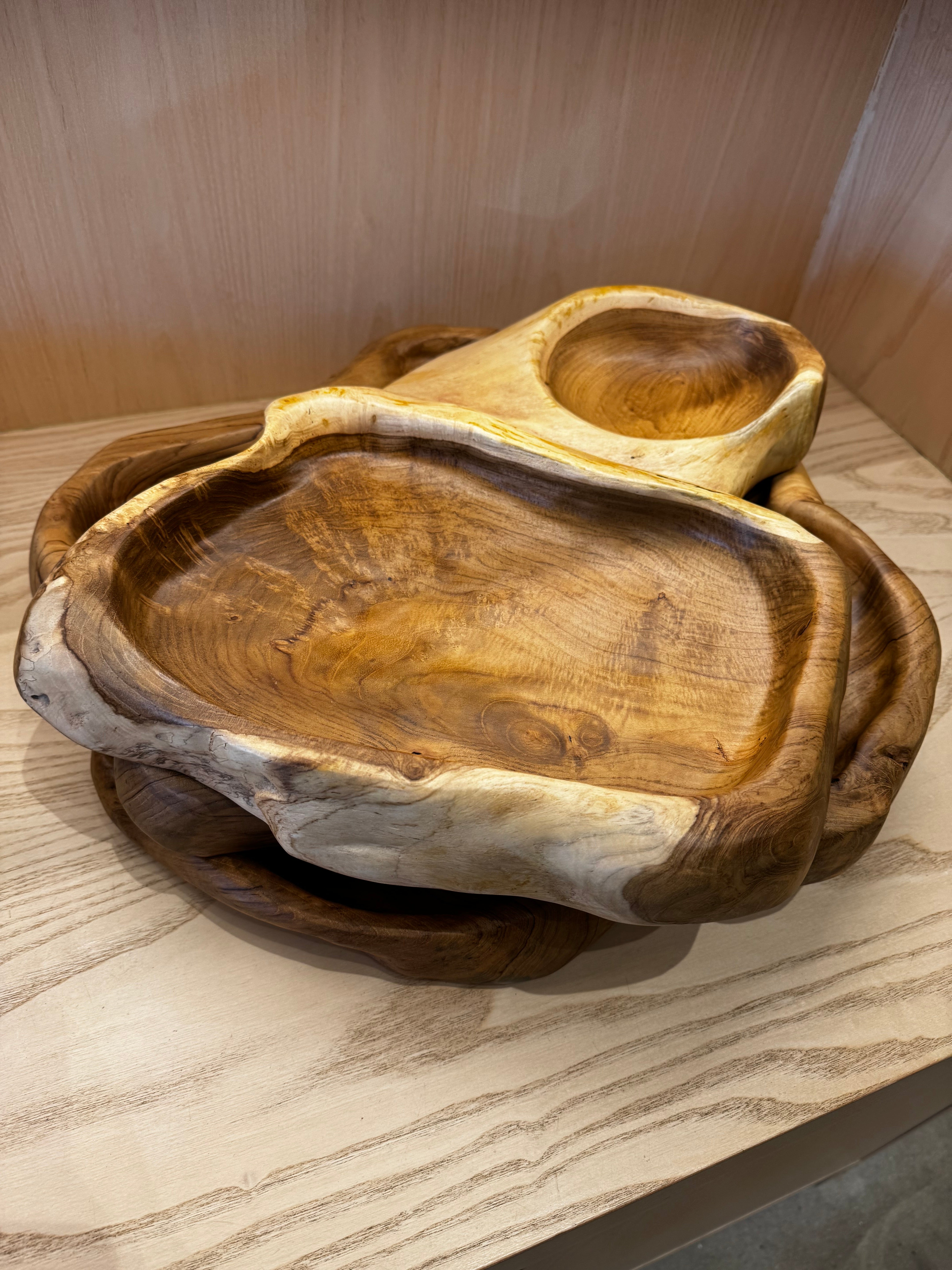 Wooden serving trays on a light wooden surface