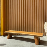 elevated charcuterie board with slatted design against a concrete wall