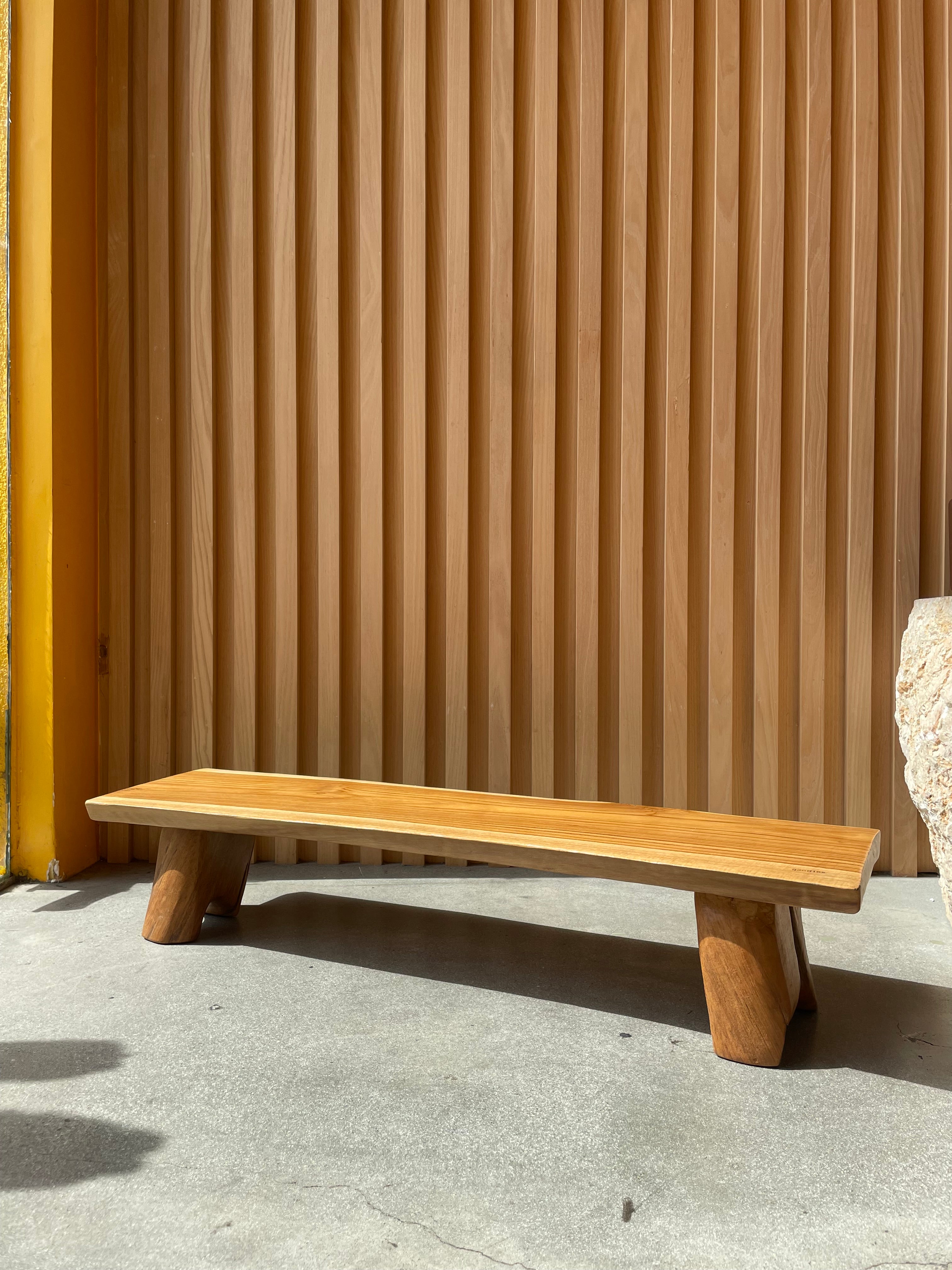 elevated charcuterie board with slatted design against a concrete wall