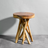 Wooden stool with a round top and twisted legs on a gray background