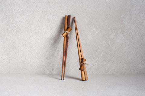 a pair of wooden chopsticks tied together