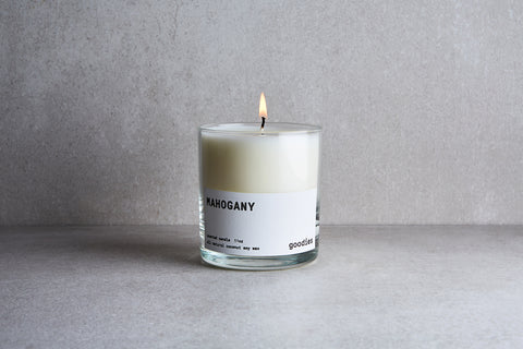 a candle in a glass container